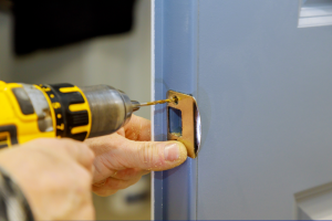 Locksmith installing a new lock on a front door in Wood Dale, Illinois